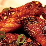 Enjoy these Fired Up Chicken Wings with a Jerk Marinade that are cooked with the Rainford Method. Ingredients 1⁄2 cup (125 ml) canola oil 1⁄4 cup (60 ml) Jerk Marinade (see below) 2 Tbsp (30 ml) chili powder 2 Tbsp (30 ml) onion powder 1 Tbsp (15 ml) garlic powder 1 Tbsp (15 ml) smoked paprika 1 Tbsp (15 ml) freshly ground black pepper 1 jalapeño chili (for less heat, seed the chili) 1 tsp (5 ml) kosher salt 1⁄2 tsp (2 ml) ground ginger 2 lb (1 kg) chicken wings Fired Up Chicken Wings Instructions Combine the oil, jerk marinade, chili powder, onion powder, garlic powder, smoked paprika, black pepper, jalapeño, salt and ground ginger in a large bowl. Add the chicken wings and toss to coat evenly. Refrigerate for at least 2 hours or up to 24 hours. Fire up your charcoal. Set up the EGG for direct cooking at 350°F/177°C. Remove the wings from the marinade, shaking off the excess. Pat the wings dry with paper towels. Grill the wings, turning once halfway through cooking, for 20 to 30 minutes or until golden and the juices run clear. Makes 2 main course servings or 10 appetizer servings. Jerk Marinade Ingredients 3⁄4 cup (185 ml) white vinegar 1⁄2 cup (125 ml) orange juice 1⁄4 cup (60 ml) olive oil 1⁄4 cup (60 ml) soy sauce 1 lime, juiced 2 Tbsp (30 ml) garlic powder 1 Tbsp (15 ml) dried thyme leaves 1 Tbsp (15 ml) ground allspice 1 1⁄2 tsp (7.5 ml) dried red chili flakes 1 1⁄2 tsp (7.5 ml) dried ground sage 1 1⁄2 tsp (7.5 ml) freshly ground black pepper 1 tsp (5 ml) kosher salt 3⁄4 tsp (4 ml) ground cinnamon 3⁄4 tsp (4 ml) ground nutmeg 1 cup (250 ml) chopped onion 3 green onions, finely chopped 1 Scotch bonnet chili, seeded and chopped Jerk Marinade Instructions Blend all ingredients together in a food processor until smooth. Makes 13⁄4 cups (450 ml). Recipe from Big Green Egg and courtesy of Robert Rainford.