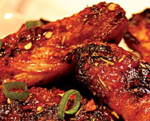 Enjoy these Fired Up Chicken Wings with a Jerk Marinade that are cooked with the Rainford Method. Ingredients 1⁄2 cup (125 ml) canola oil 1⁄4 cup (60 ml) Jerk Marinade (see below) 2 Tbsp (30 ml) chili powder 2 Tbsp (30 ml) onion powder 1 Tbsp (15 ml) garlic powder 1 Tbsp (15 ml) smoked paprika 1 Tbsp (15 ml) freshly ground black pepper 1 jalapeño chili (for less heat, seed the chili) 1 tsp (5 ml) kosher salt 1⁄2 tsp (2 ml) ground ginger 2 lb (1 kg) chicken wings Fired Up Chicken Wings Instructions Combine the oil, jerk marinade, chili powder, onion powder, garlic powder, smoked paprika, black pepper, jalapeño, salt and ground ginger in a large bowl. Add the chicken wings and toss to coat evenly. Refrigerate for at least 2 hours or up to 24 hours. Fire up your charcoal. Set up the EGG for direct cooking at 350°F/177°C. Remove the wings from the marinade, shaking off the excess. Pat the wings dry with paper towels. Grill the wings, turning once halfway through cooking, for 20 to 30 minutes or until golden and the juices run clear. Makes 2 main course servings or 10 appetizer servings. Jerk Marinade Ingredients 3⁄4 cup (185 ml) white vinegar 1⁄2 cup (125 ml) orange juice 1⁄4 cup (60 ml) olive oil 1⁄4 cup (60 ml) soy sauce 1 lime, juiced 2 Tbsp (30 ml) garlic powder 1 Tbsp (15 ml) dried thyme leaves 1 Tbsp (15 ml) ground allspice 1 1⁄2 tsp (7.5 ml) dried red chili flakes 1 1⁄2 tsp (7.5 ml) dried ground sage 1 1⁄2 tsp (7.5 ml) freshly ground black pepper 1 tsp (5 ml) kosher salt 3⁄4 tsp (4 ml) ground cinnamon 3⁄4 tsp (4 ml) ground nutmeg 1 cup (250 ml) chopped onion 3 green onions, finely chopped 1 Scotch bonnet chili, seeded and chopped Jerk Marinade Instructions Blend all ingredients together in a food processor until smooth. Makes 13⁄4 cups (450 ml). Recipe from Big Green Egg and courtesy of Robert Rainford.